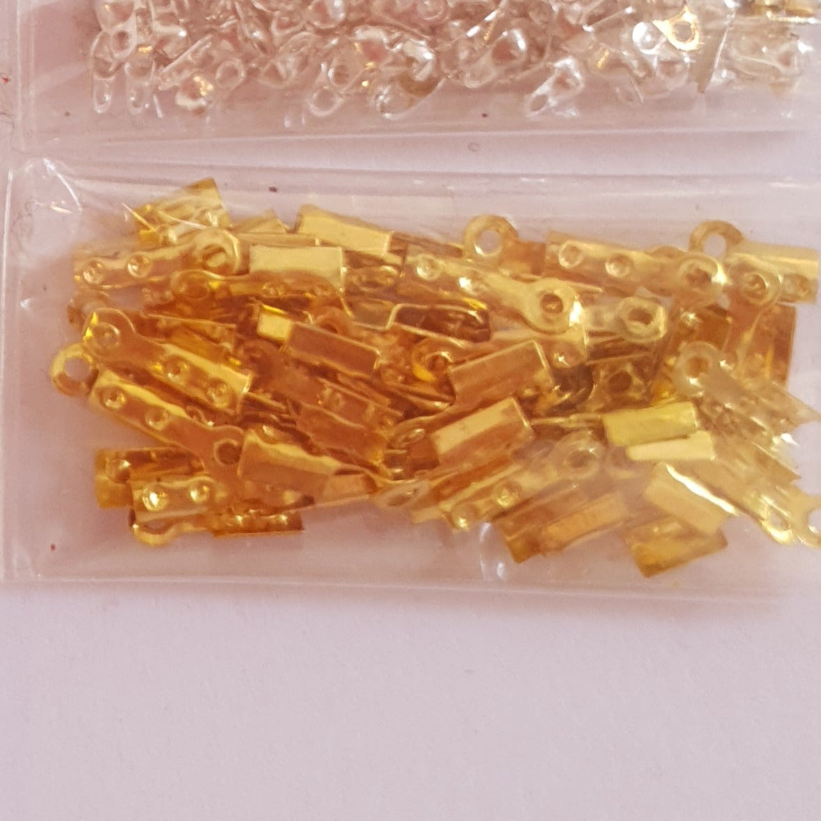 Terminals for costume jewelery (cable lug and knot cover)